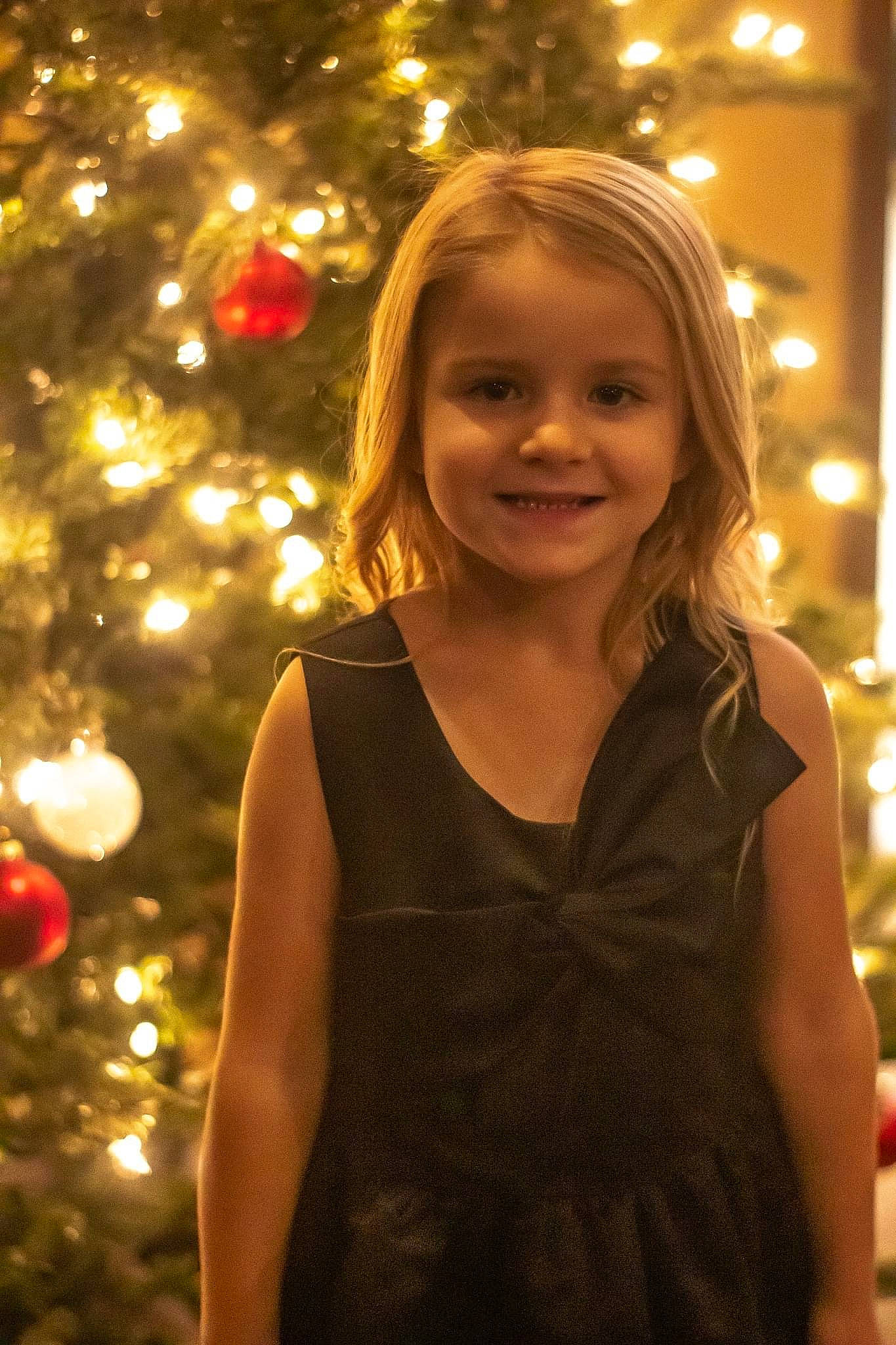 Makenna joined the competition — help win amazing prizes! beauty, christmas, christmas_ornament, christmas_tree, event, evergreen, flash_photography, fun, happy, head, holiday, holiday_ornament, iris, joy, light, long_hair, ornament, people_in_nature, person, smile
