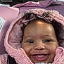 Akira joined the competition — help win amazing prizes! baby, smiling, pink_jacket, curly_hair, bow, car_seat, child, closeup, face, happy, infant, cute, warm_clothing, seatbelt, portrait, indoors, young_child, joyful, skin, expression