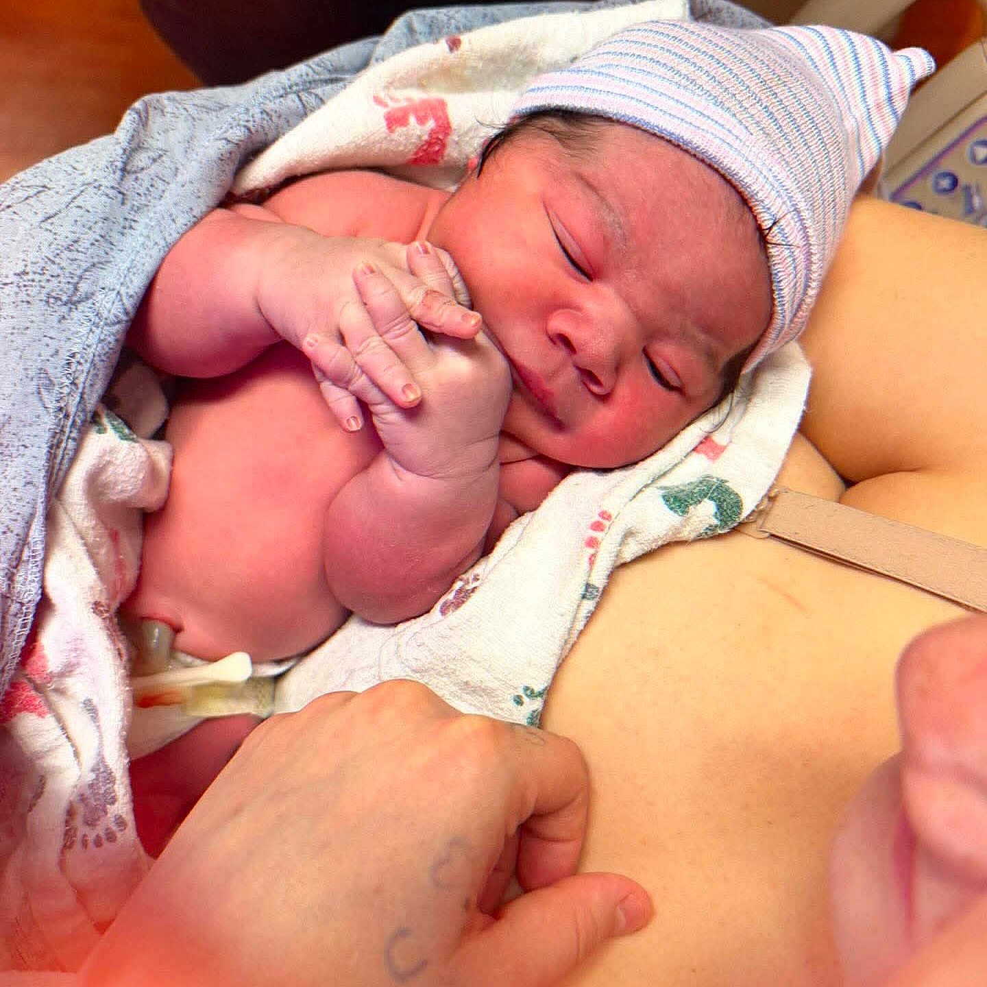 Syreese is registered to the contest to win money with this photo: baby, bed, blanket, closeup, cute, hand, hat, hospital, infant, medical_equipment, newborn, newborn_room, parent, portrait, postpartum, skin, sleeping, swaddle, towel, umbilical_clamp