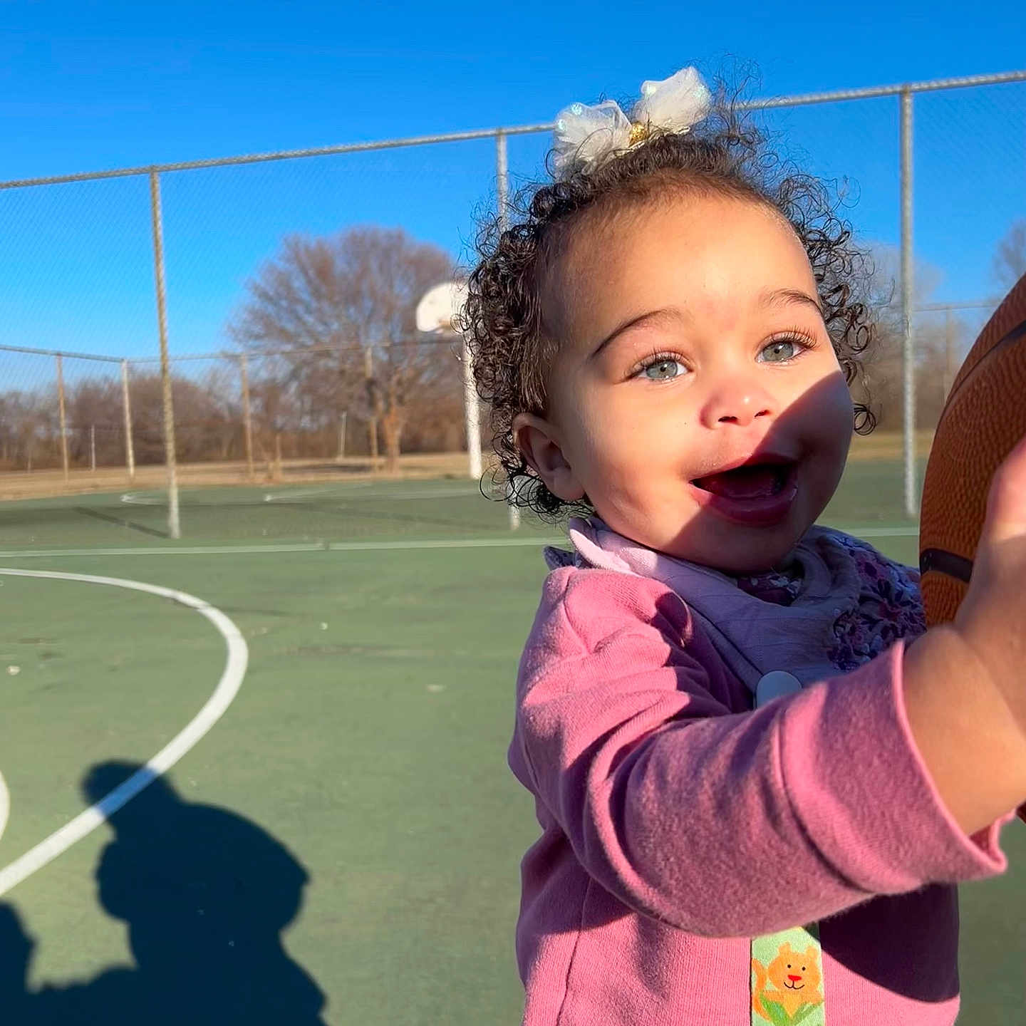 Taliyah joined the competition — help win amazing prizes! baby, basketball, bodypart, curlyhair, face, finger, grass, hair, hand, happy, head, outdoorplayarea, outdoors, person, photography, playarea, playingbasketball, portrait, smile, sport