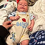 Evo joined the competition — help win amazing prizes! baby, infant, romper, bluey, hand, pillow, blanket, remote_control, game_controller, couch, clothing, smiling, face, comfort, indoors, person, child, cute, relaxed, cozy