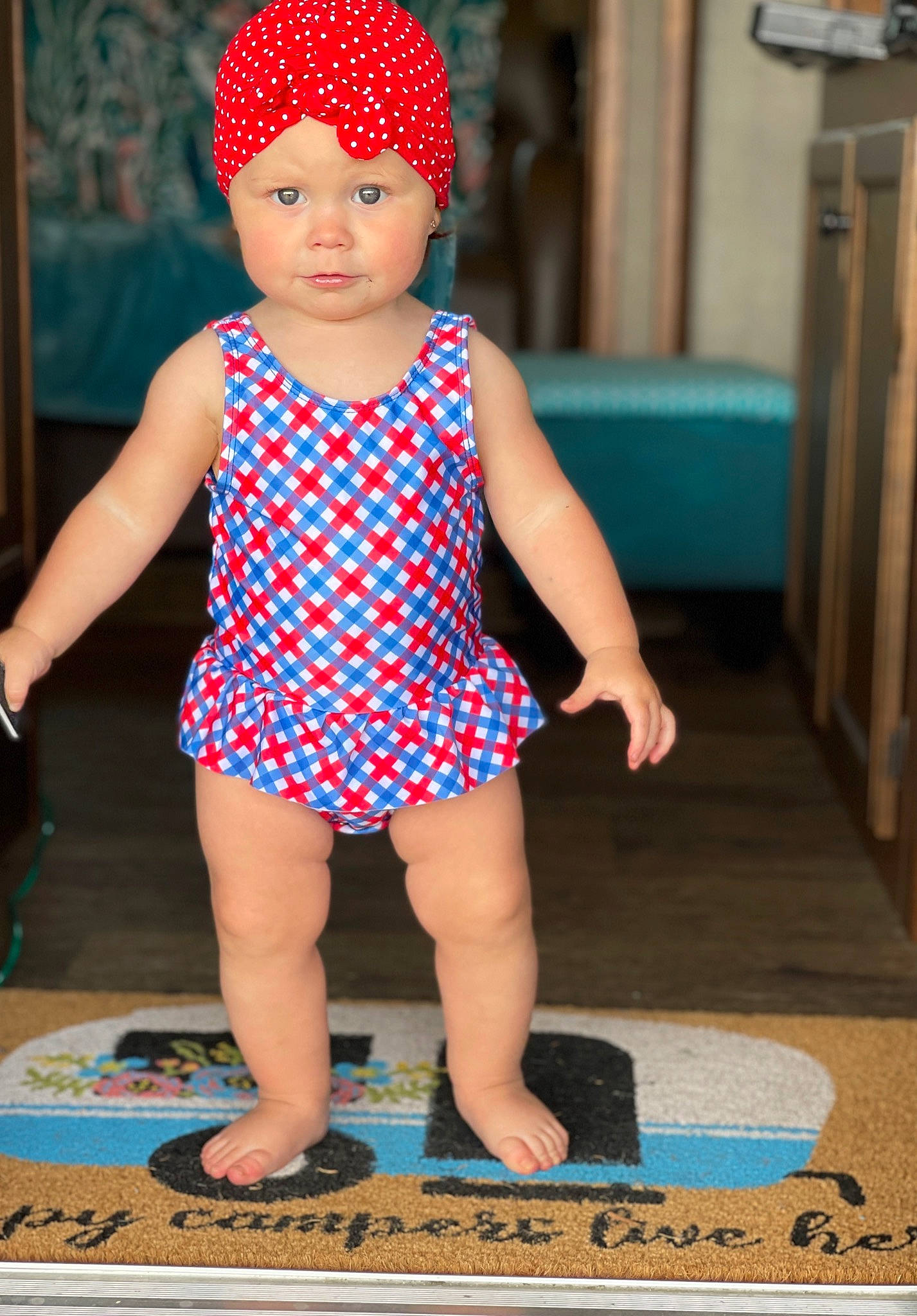 Aviana is registered to the contest to win money with this photo: aqua, baby, baby_toddler_clothing, cap, child, costume_hat, electric_blue, fashion_accessory, finger, flooring, fun, headwear, human, magenta, nail, pattern, person, pink, red, standing