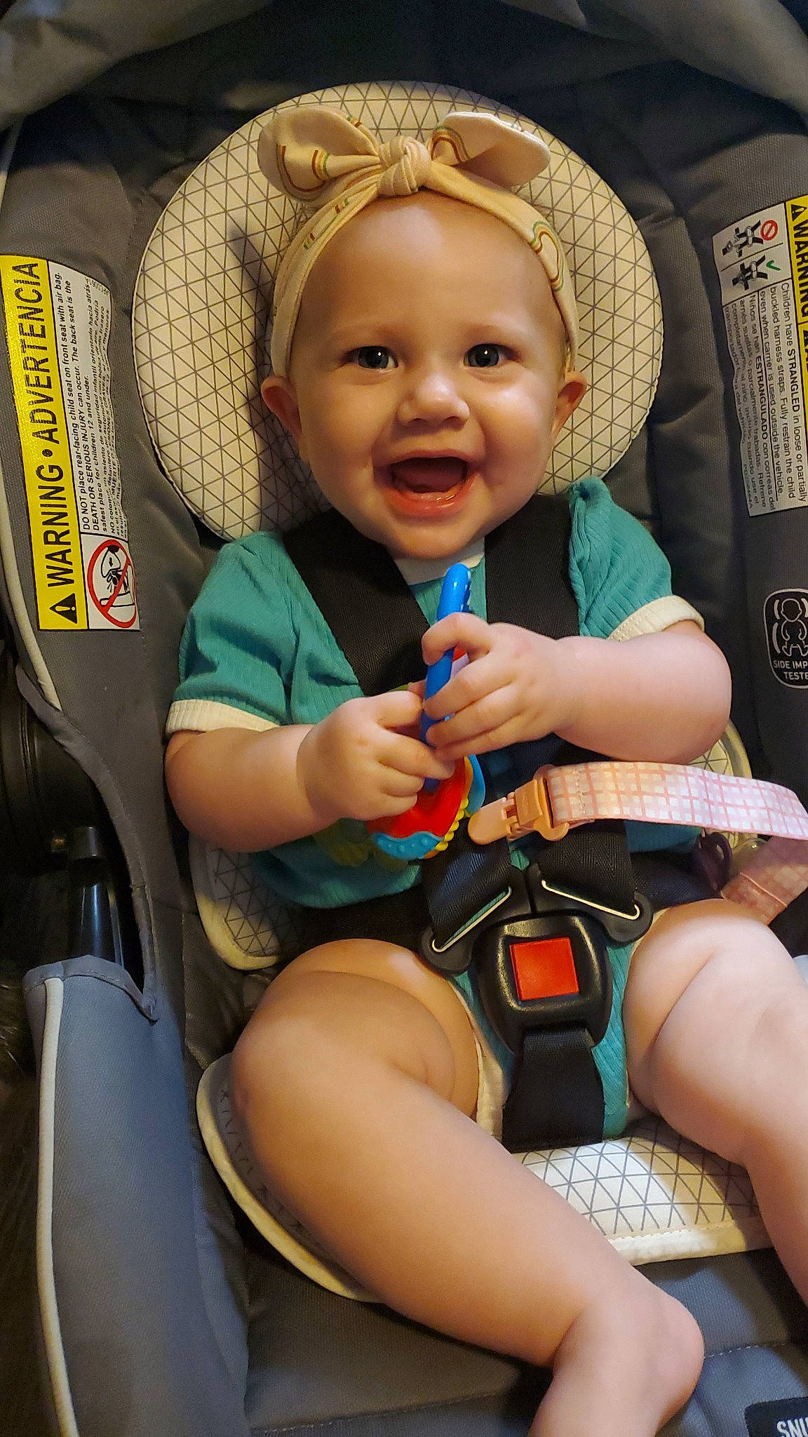 Ella is registered to the contest to win money with this photo: baby, baby_carriage, car_seat, chair, cheek, child, comfort, eye, finger, fun, happy, human_body, leisure, organ, person, product, skin, smile, steering_wheel, thigh