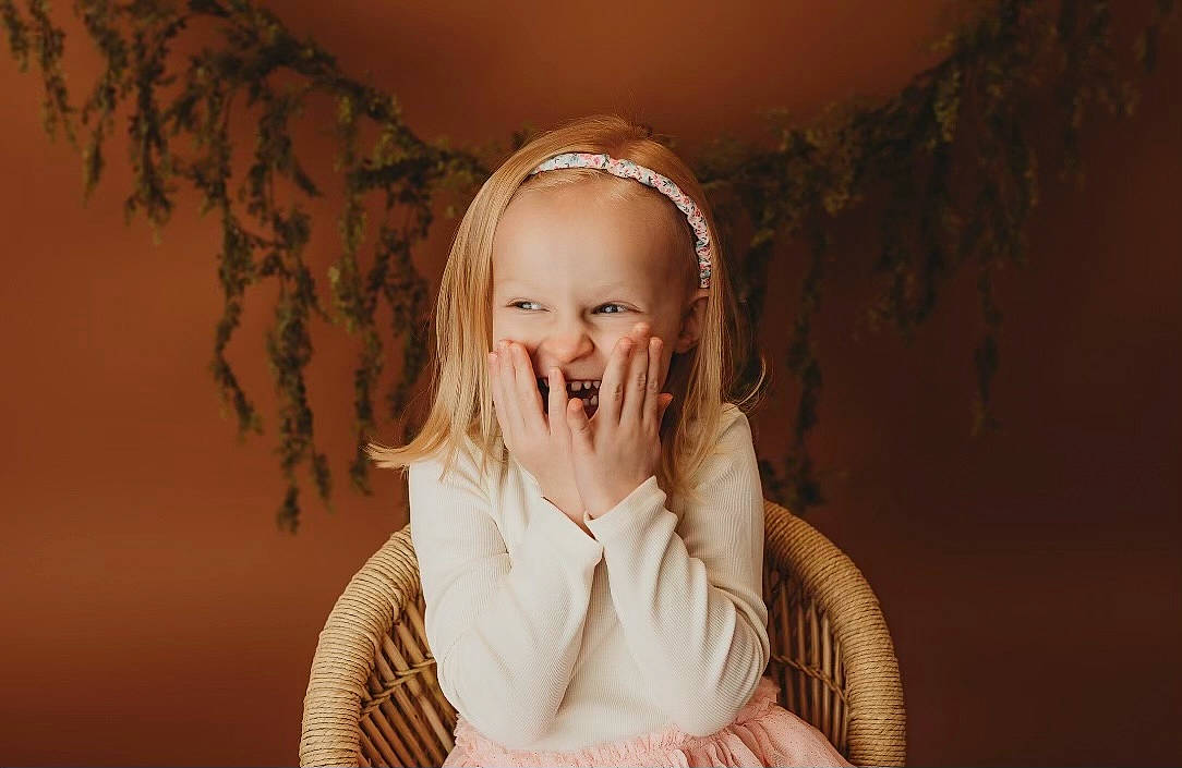 Monroe is registered to the contest to win money with this photo: brown_hair, child, event, eyelash, fashion_accessory, flash_photography, fun, fur, gesture, happy, headpiece, jewellery, laugh, lip, long_hair, person, portrait_photography, sitting, smile, toddler