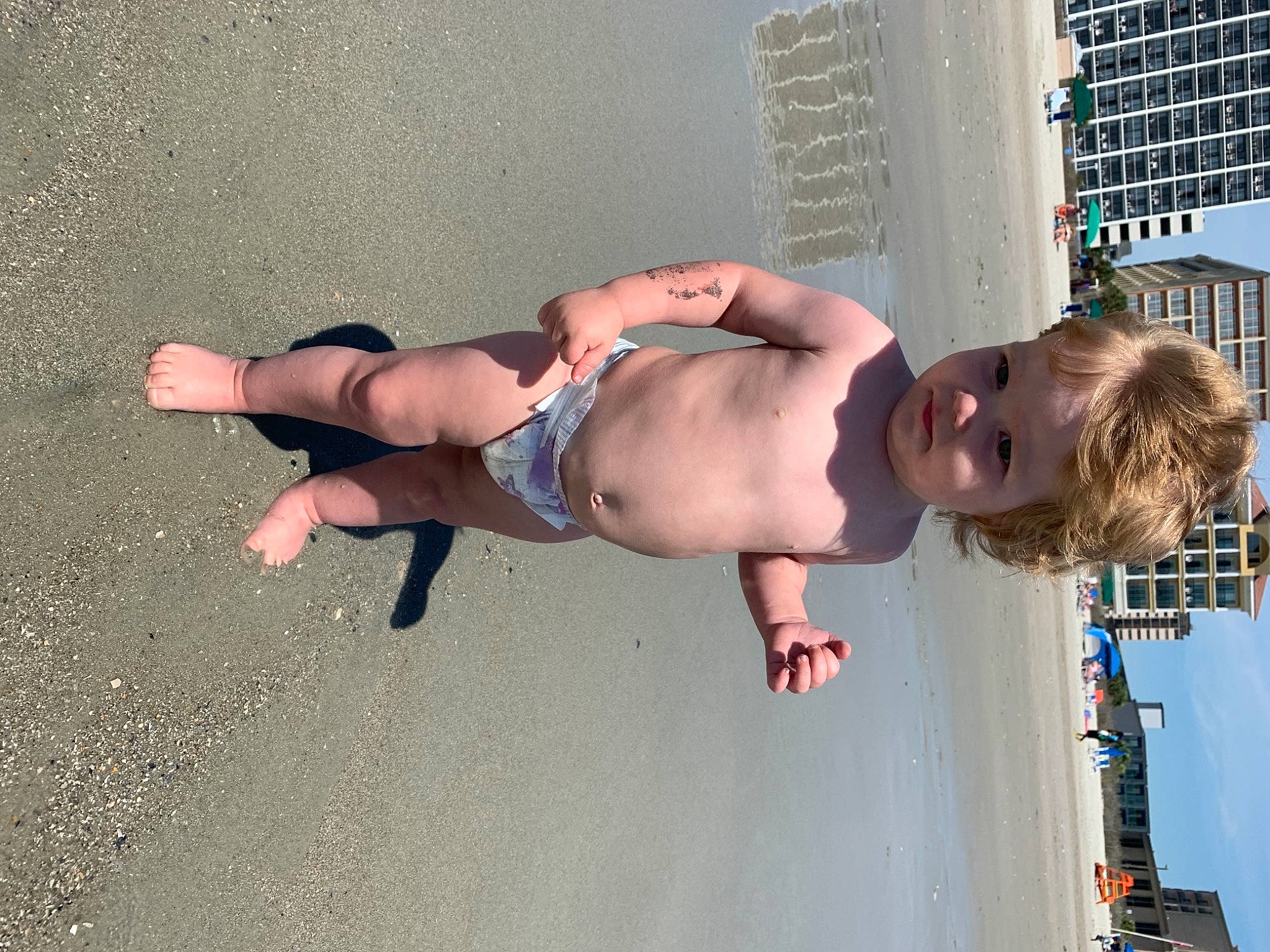 Gary is registered to the contest to win money with this photo: abdomen, barechested, chest, elbow, fun, human_body, human_leg, joint, knee, leg, leisure, navel, person, shoulder, sky, swimwear, thigh, toddler, trunk, trunks