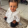 Zayna participe au concours pour gagner de l'argent avec cette photo : candid, carpet, child, cute, floor_tiles, furniture, hair_buns, hand, happy, home, indoor, person, polka_dot_leggings, portrait, smile, socks, stroller, toddler, white_top, young_child