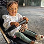 Zayna participe au concours pour gagner de l'argent avec cette photo : child, concrete_ground, cute, fabric, face, glass_doors, green_leggings, hands, happy, outdoor, pacifier, person, pigtails, safety_bar, sandals, smiling, stroller, toddler, urban, white_blouse