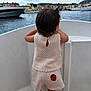 back_view, barefoot, boat, buildings, child, clouds, crocheted_clothing, cute, hair_ponytail, harbor, marina, outdoor, peaceful, sailboat, sky, strawberry_patch, summer, toddler, vacation, water