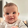 baby, blurred_background, cheeks, child, closeup, cute, eyes, face, happy, head, human, indoors, infant, person, portrait, skin, smile, soft_light, white_shirt, young_child
