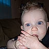 Liam is registered to the contest to win money with this photo: baby, child, blue_eyes, curly_hair, indoor, close_up, hand_in_mouth, cute, infant, portrait, person, skin, face, eyelashes, expression, couch, cozy, young, curiosity, soft_light