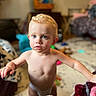 Liam joined the competition — help win amazing prizes! toddler, child, indoor, blond_hair, blue_eyes, curly_hair, diaper, living_room, furniture, toy, carpet, blanket, couch, person, young_child, cute, curious, baby, home, portrait