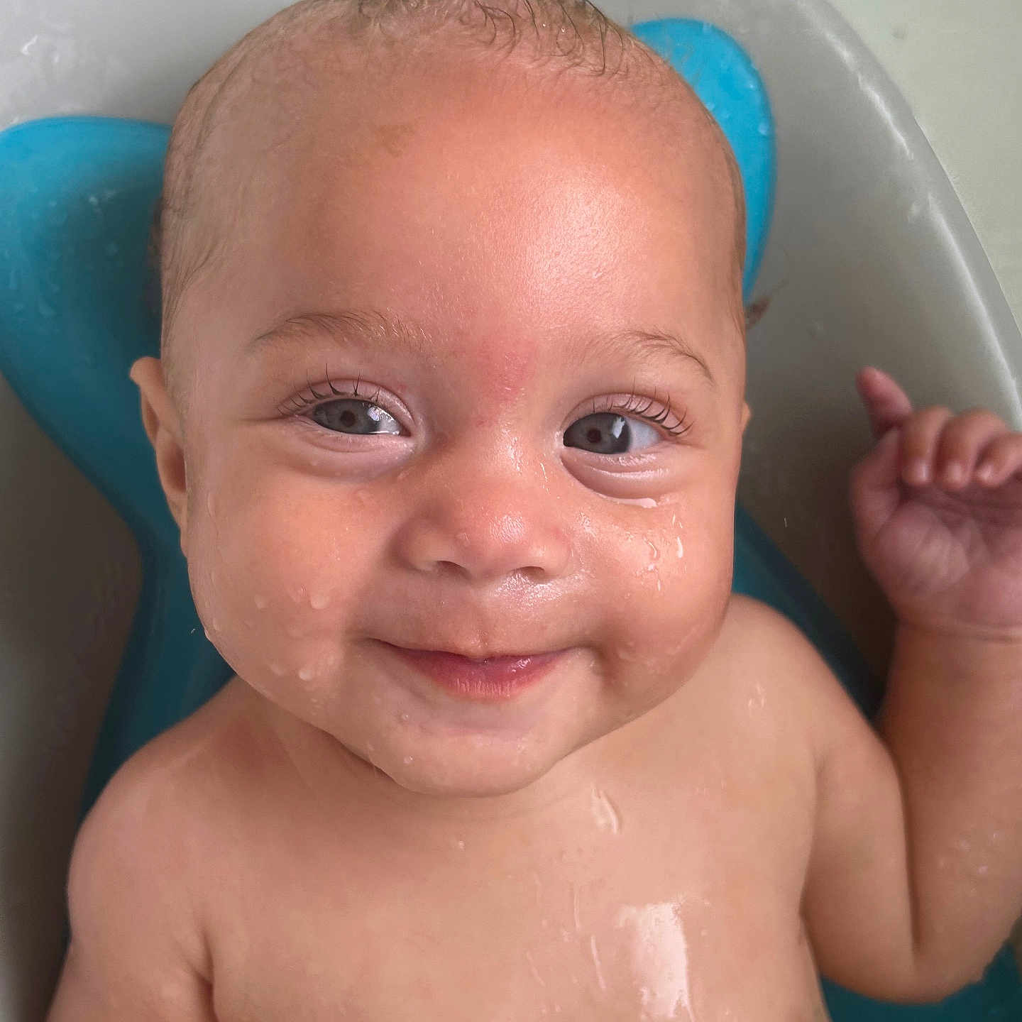 Elowynn is registered to the contest to win money with this photo: baby, background, bath, blue, cheek, child, cute, expression, eyes, face, hand, head, infant, joy, portrait, relax, skin, smile, water, wet