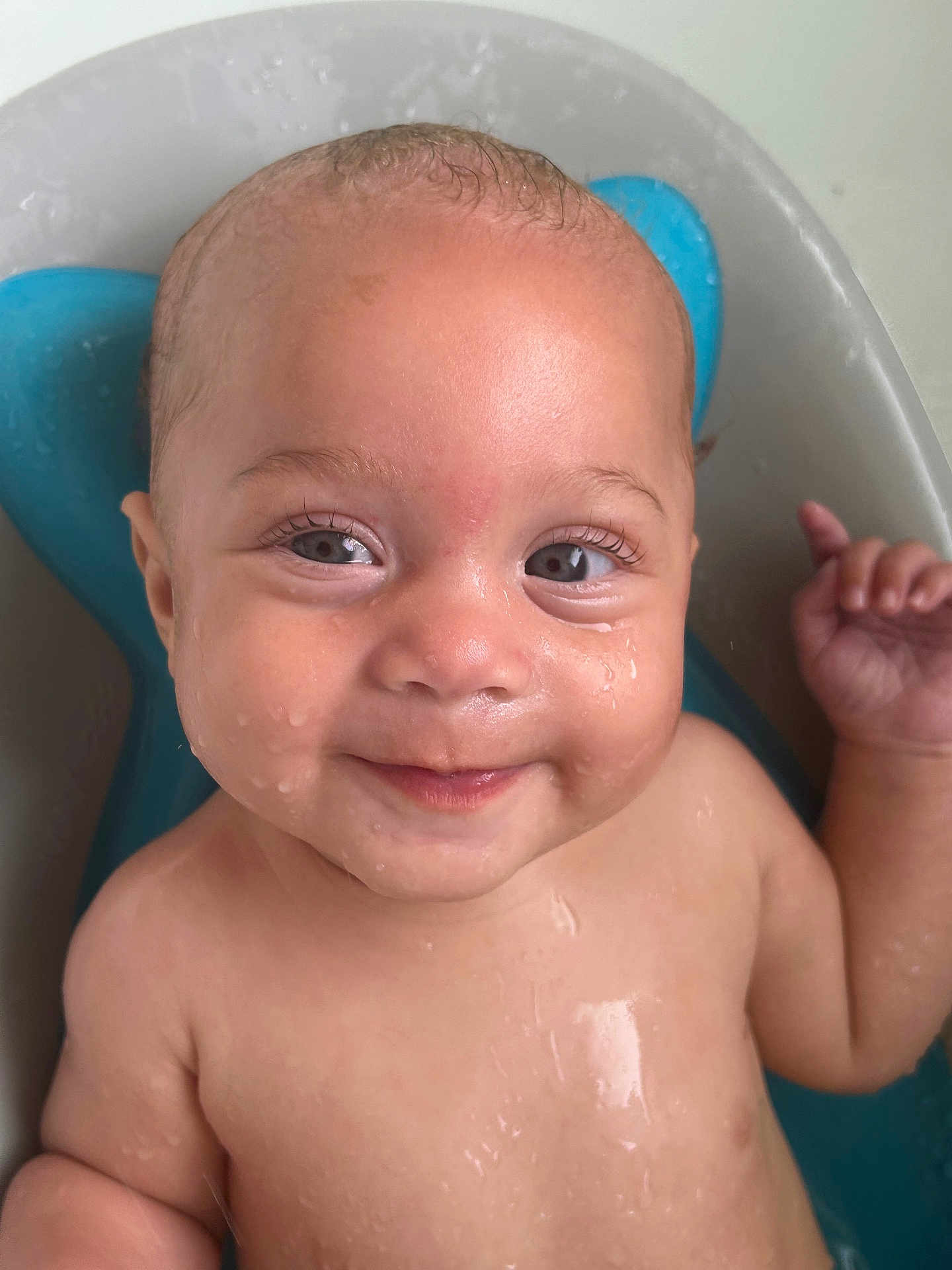Elowynn is registered to the contest to win money with this photo: baby, child, smile, face, water, bath, wet, skin, eyes, cheek, hand, head, expression, joy, infant, cute, portrait, relax, blue, background