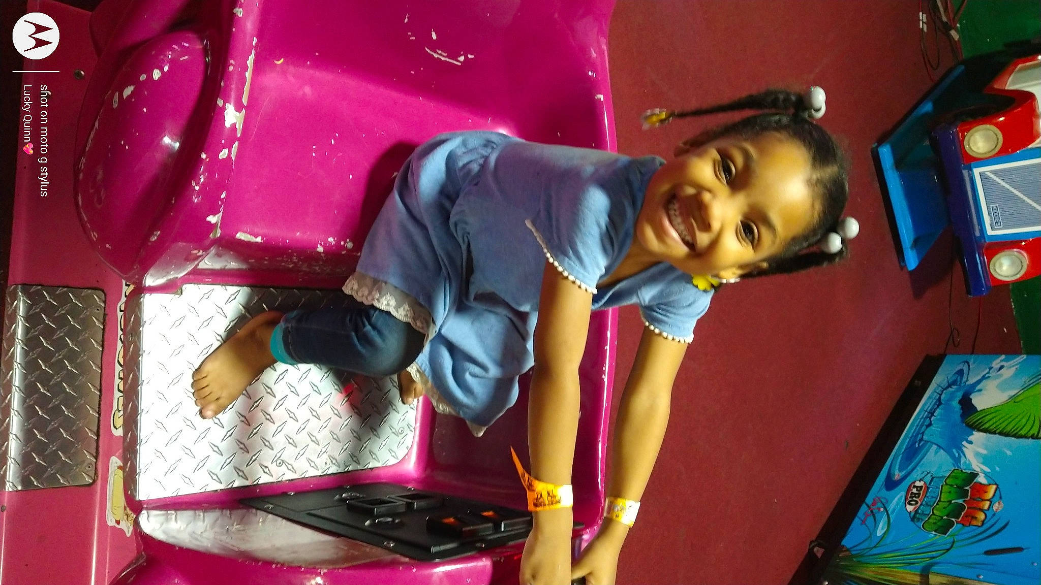 Nyalise is registered to the contest to win money with this photo: black_hair, bumper, child, entertainment, event, facial_expression, fun, happy, joy, leisure, magenta, person, pink, play, playground, purple, recreation, room, smile, t_shirt
