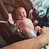 Eliana is registered to the contest to win money with this photo: baby, car_seat, infant, smile, diaper, arm, hand, blanket, bunny_pattern, pink, black, person, child, cute, indoor, happy, seat, comfort, skin, infancy