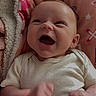 baby, infant, smiling, happy, blanket, letters, stars, clothing, cute, face, skin, expression, newborn, child, person, indoors, soft, lying_down, joyful, fist