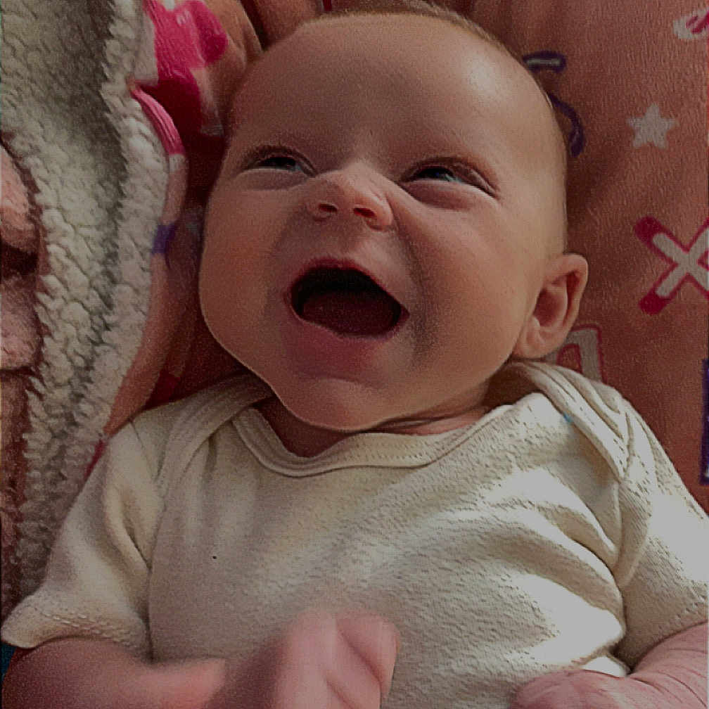 Zia joined the competition — help win amazing prizes! baby, infant, smiling, happy, blanket, letters, stars, clothing, cute, face, skin, expression, newborn, child, person, indoors, soft, lying_down, joyful, fist