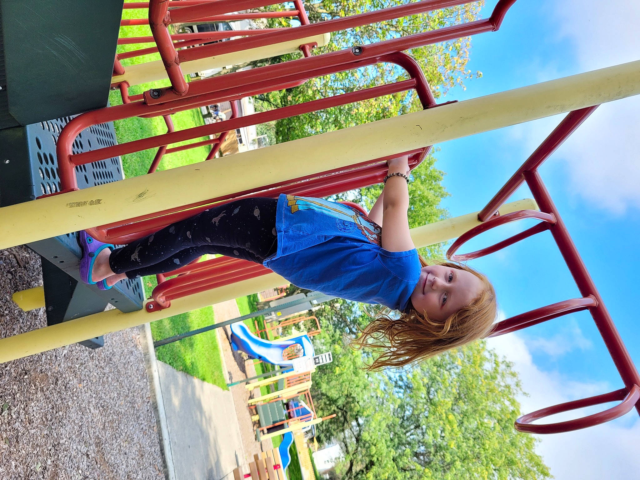 Genevieve is registered to the contest to win money with this photo: city, clothing, cloud, electric_blue, fun, happy, joy, leisure, light, nonbuilding_structure, outdoor_play_equipment, person, plant, play, playground, pole, recreation, red, sky, t_shirt