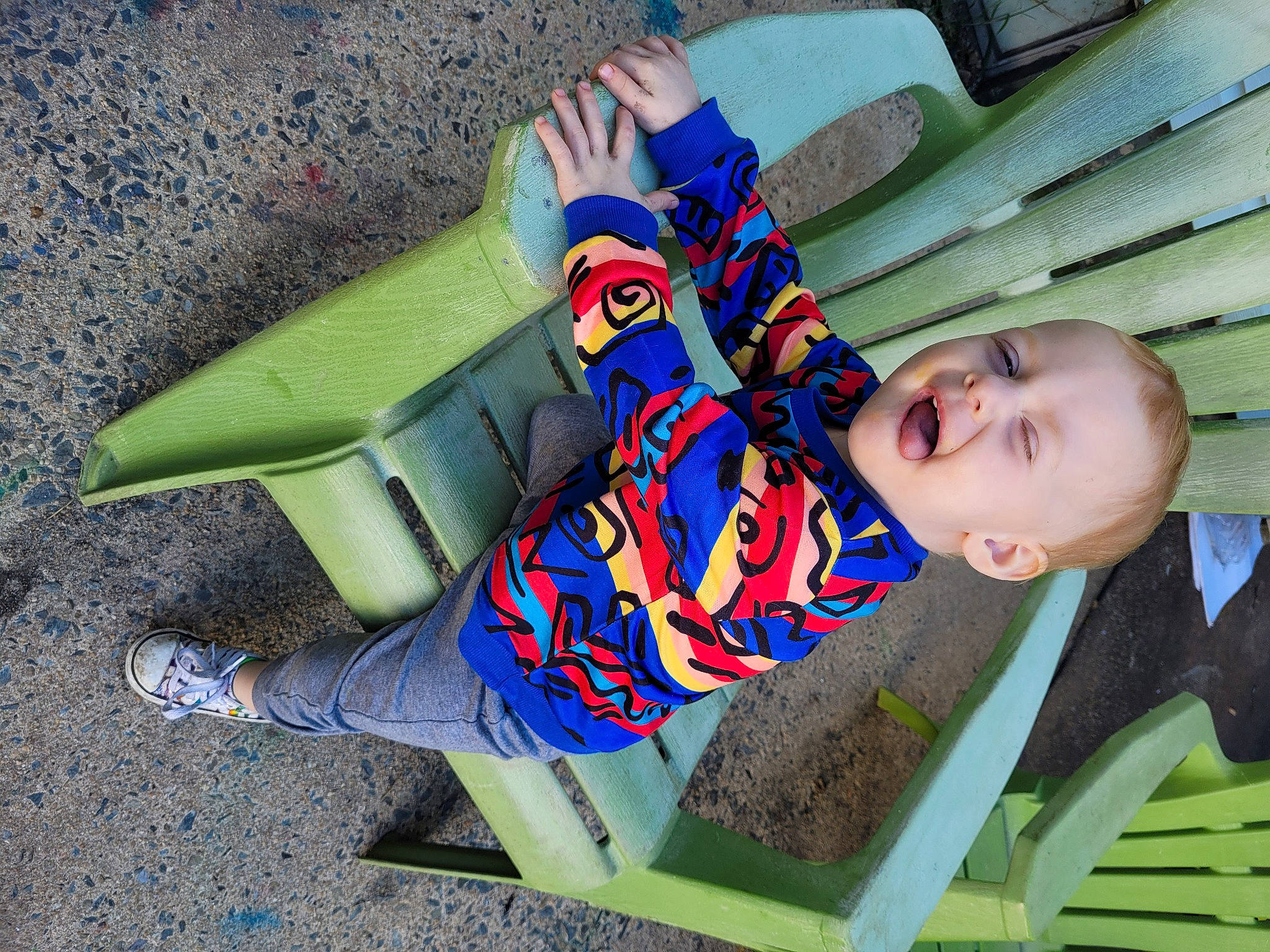 River is registered to the contest to win money with this photo: book, child, comfort, electric_blue, fun, grass, happy, leisure, pattern, people_in_nature, person, play, reading, recreation, sitting, wood