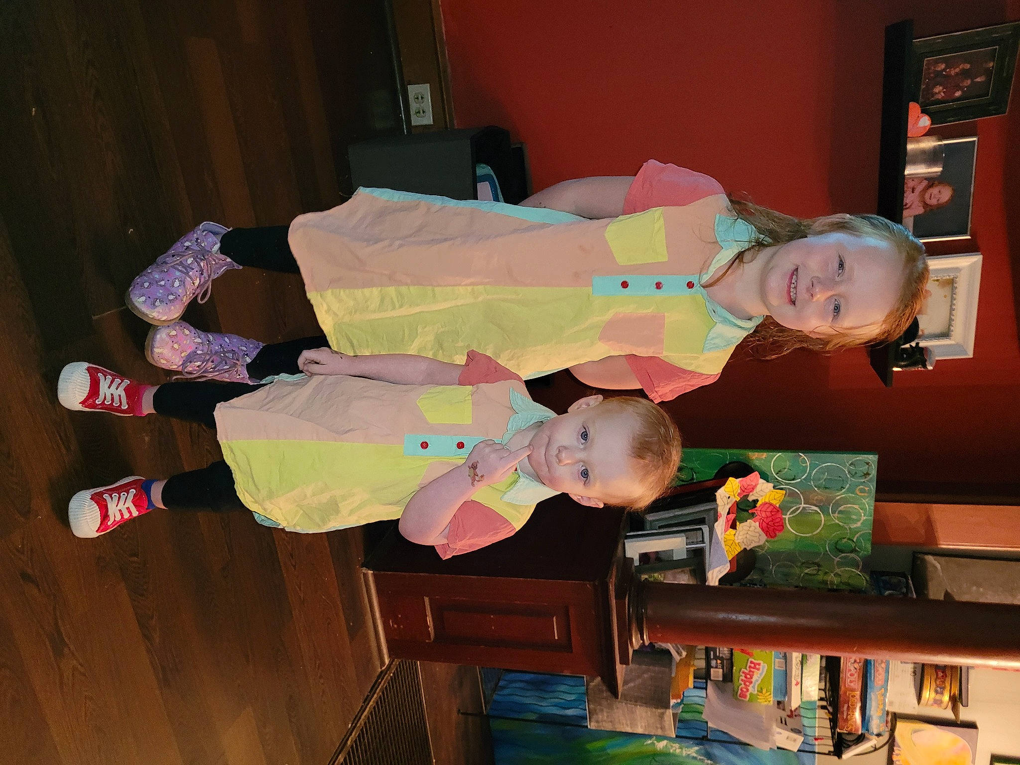 River is registered to the contest to win money with this photo: baby, baby_products, baby_toddler_clothing, bookcase, child, costume, fun, happy, hardwood, joy, person, picture_frame, room, shelf, shelving, smile, toddler, toy, wood