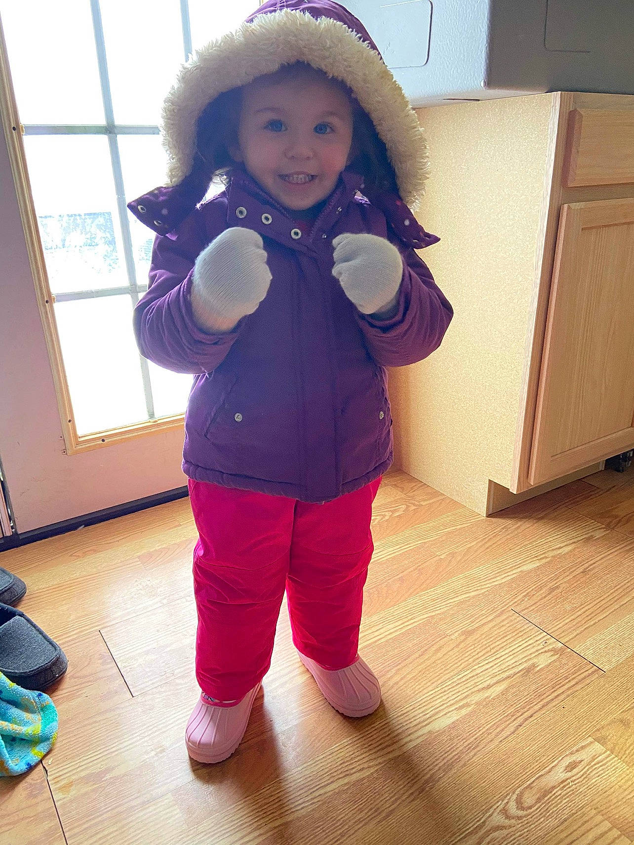 Ava is registered to the contest to win money with this photo: baby_toddler_clothing, eye, floor, flooring, fun, happy, head, headwear, joy, knee, person, purple, skin, sleeve, smile, sportswear, standing, sun_hat, thigh, toddler