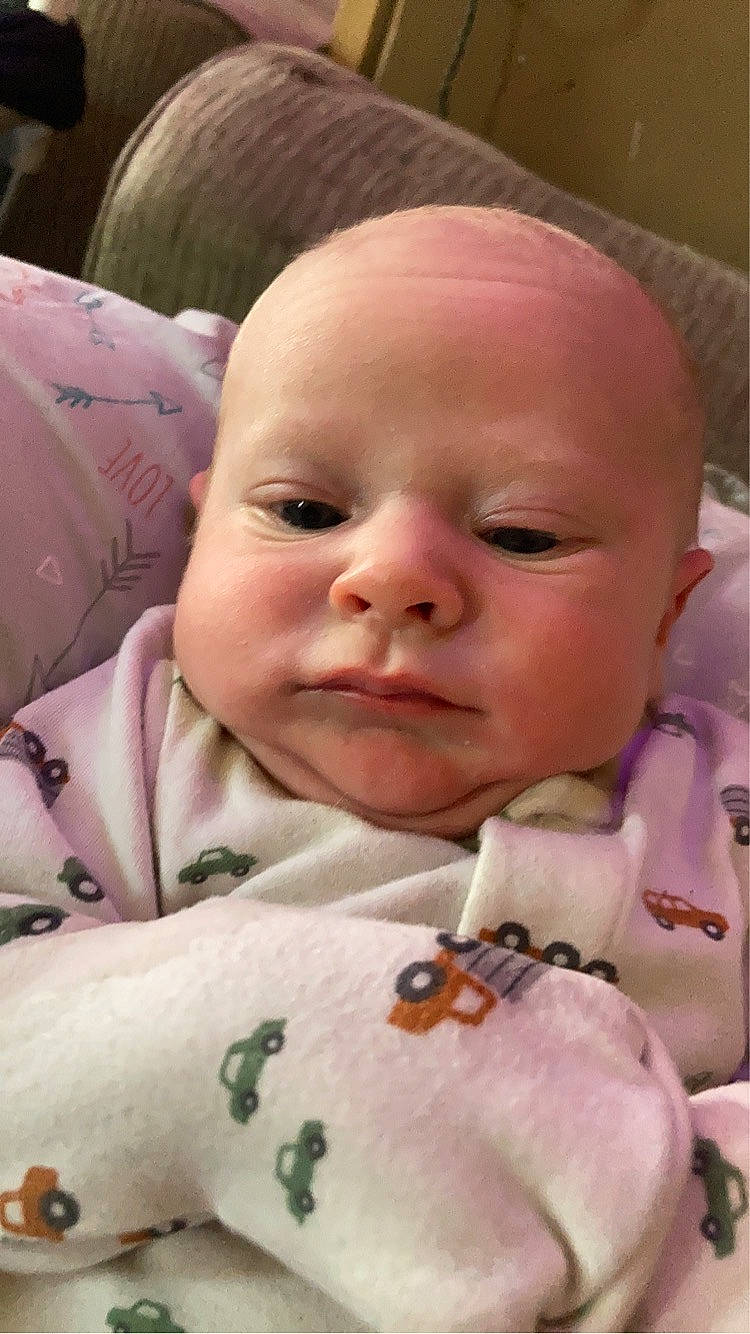 Zachary is registered to the contest to win money with this photo: baby, baby_toddler_clothing, cheek, child, chin, comfort, eyebrow, face, iris, lip, mouth, nose, person, pink, product, skin, sleeve, smile, textile, toddler