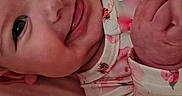 Callie Rae joined the competition — help win amazing prizes! baby, cheeks, child, closeup, cute, eyes, face, floral_clothing, hand, happy, indoors, infant, lying_down, mesh_barrier, newborn, pink, portrait, skin, smiling, soft_light