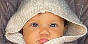 Emy participe au concours pour gagner de l'argent avec cette photo : baby, child, face, hood, knitwear, sweater, close_up, portrait, cute, warm_clothing, infant, looking_at_camera, cozy, soft_texture, expression, young_child, adorable, eyes, skin, button