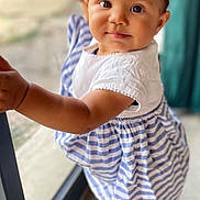Emy a rejoint le concours — aidez-le/la à gagner de superbes lots ! toddler, child, baby, standing, dress, striped, hair_bows, glass_door, indoors, curious, cute, portrait, smiling, young_child, person, skin, face, eyes, hand, foot