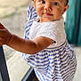 toddler, child, baby, standing, dress, striped, hair_bows, glass_door, indoors, curious, cute, portrait, smiling, young_child, person, skin, face, eyes, hand, foot
