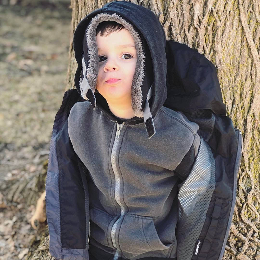 Jaxsen is registered to the contest to win money with this photo: beauty, black_hair, child, eye, fashion, fur, headgear, hood, hoodie, jacket, jeans, lip, long_hair, outerwear, person, photography, sleeve, smile, tree, winter
