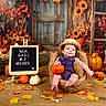 baby, infant, child, portrait, sitting, smiling, straw_hat, overalls, pumpkin, autumn, fall, leaves, flowers, sunflowers, rustic, farmhouse, wooden_background, harvest, chair, seasonal_photography