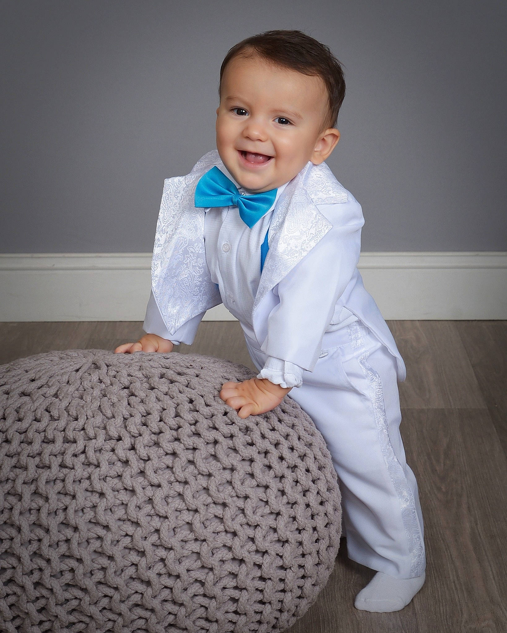 Leo is registered to the contest to win money with this photo: baby_toddler_clothing, child, comfort, electric_blue, face, flash_photography, flooring, formal_wear, happy, human_body, joy, linens, neck, outerwear, pattern, person, shoulder, sitting, sleeve, smile