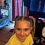 Angel joined the competition — help win amazing prizes! child, girl, smile, pigtails, yellow_tshirt, indoor, room, bed, television, cartoon, wooden_floor, curtains, backpack, casual, happy, portrait, person, home, furniture, light