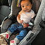 Tadeo is registered to the contest to win money with this photo: baby, car_seat, child, infant, jeans, white_shirt, sneakers, seatbelt, car_interior, clothing, footwear, person, seat, cute, portrait, young_child, sitting, hands, expression, indoor