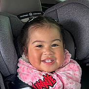 Gabriela is registered to the contest to win money with this photo: child, toddler, car_seat, smiling, pink_jacket, fleece, happy, face, hair, seatbelt, interior, vehicle, cute, portrait, baby, clothing, young_child, sitting, car, child_safety_seat