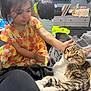 Manny joined the competition — help win amazing prizes! blanket, casual_clothing, cat, child, citrus_pattern, colorful, cute, family, furniture, happy, home, indoor, interaction, petting, playroom, relaxed, soft_lighting, tabby_cat, television, young_child