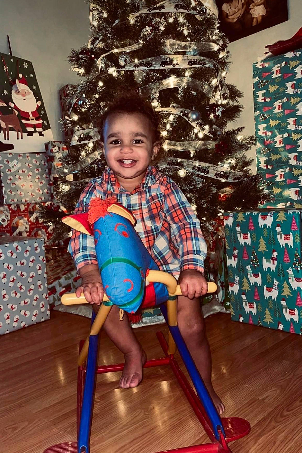 Keaton is registered to the contest to win money with this photo: baby_toddler_clothing, child, christmas_decoration, christmas_ornament, christmas_tree, event, fun, happy, hardwood, holiday, holiday_ornament, joy, lap, ornament, person, sitting, smile, standing, toddler, tree