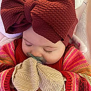 Ivy joined the competition — help win amazing prizes! baby, child, sleeping, headband, bow, mittens, pacifier, blanket, sweater, colorful_clothing, closeup, cute, infant, cozy, soft_texture, resting, peaceful, indoor, portrait, hands