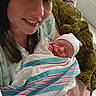 Stetson joined the competition — help win amazing prizes! woman, newborn, baby, hospital, blanket, bed, person, smile, mother, infant, gown, hat, medical, hospital_room, holding, plush_toy, resting, indoors, family, portrait