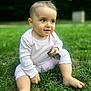 baby, child, grass, outdoor, stick, sitting, happy, curious, pink_clothing, barefoot, greenery, nature, portrait, young_child, infant, cute, hair_tuft, daylight, smiling, playful