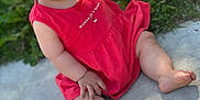 Ayana participe au concours pour gagner de l'argent avec cette photo : baby, child, smiling, red_dress, outdoor, grass, concrete, barefoot, happy, cute, sitting, skin, face, portrait, young_child, sunlight, nature, toes, person, infant