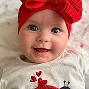 Athénaïs a rejoint le concours — aidez-le/la à gagner de superbes lots ! baby, child, smiling, face, headband, red_bow, blue_eyes, white_shirt, ladybug, hearts, cute, portrait, closeup, infant, happy, indoors, apparel, clothing, person, adorable