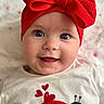 baby, child, smiling, face, headband, red_bow, blue_eyes, white_shirt, ladybug, hearts, cute, portrait, closeup, infant, happy, indoors, apparel, clothing, person, adorable