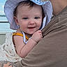 Saylor is registered to the contest to win money with this photo: adult, arm, baby, blue, checkered, child, clothing, daylight, happy, hat, holding, nature, outdoor, person, portrait, smile, sunhat, tattoo, water, white