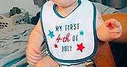 Saylor is registered to the contest to win money with this photo: adult_arm, baby, bed, bib, blanket, celebration, child, clothing, curious, curtains, cute, headband, holiday, indoor, person, portrait, sitting, striped_onesie, white_shoes, window