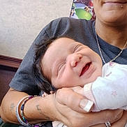 Devyn is registered to the contest to win money with this photo: baby, woman, smiling, indoor, holding, happy, face, person, jewelry, bracelet, ring, clothing, portrait, skin, hand, nail, expression, infant, cute, love