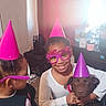 Hershey Kisses is registered to the contest to win money with this photo: birthday, birthday_glasses, brown_dog, celebration, child, children, clothing, dog, family, furniture, holding, indoors, party, party_hat, pet, photograph, pink, portrait, purple, smiling