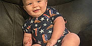 Rowdy joined the competition — help win amazing prizes! baby, infant, child, smile, sitting, onesie, clothing, couch, leather, foot, hand, face, head, indoors, furniture, cute, happy, skin, person, portrait
