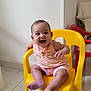 Athéna a rejoint le concours — aidez-le/la à gagner de superbes lots ! baby, child, smiling, yellow_chair, plastic_chair, indoor, floor_tiles, casual_clothing, happy, cute, seated, infant, person, shorts, top, footwear_free, armrest, head, face, playful